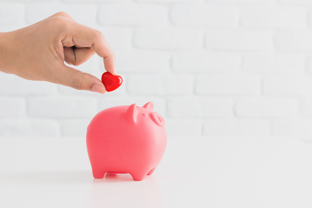 a phot of a love heart entering a piggy bank to denote joint account activity on valentine's day