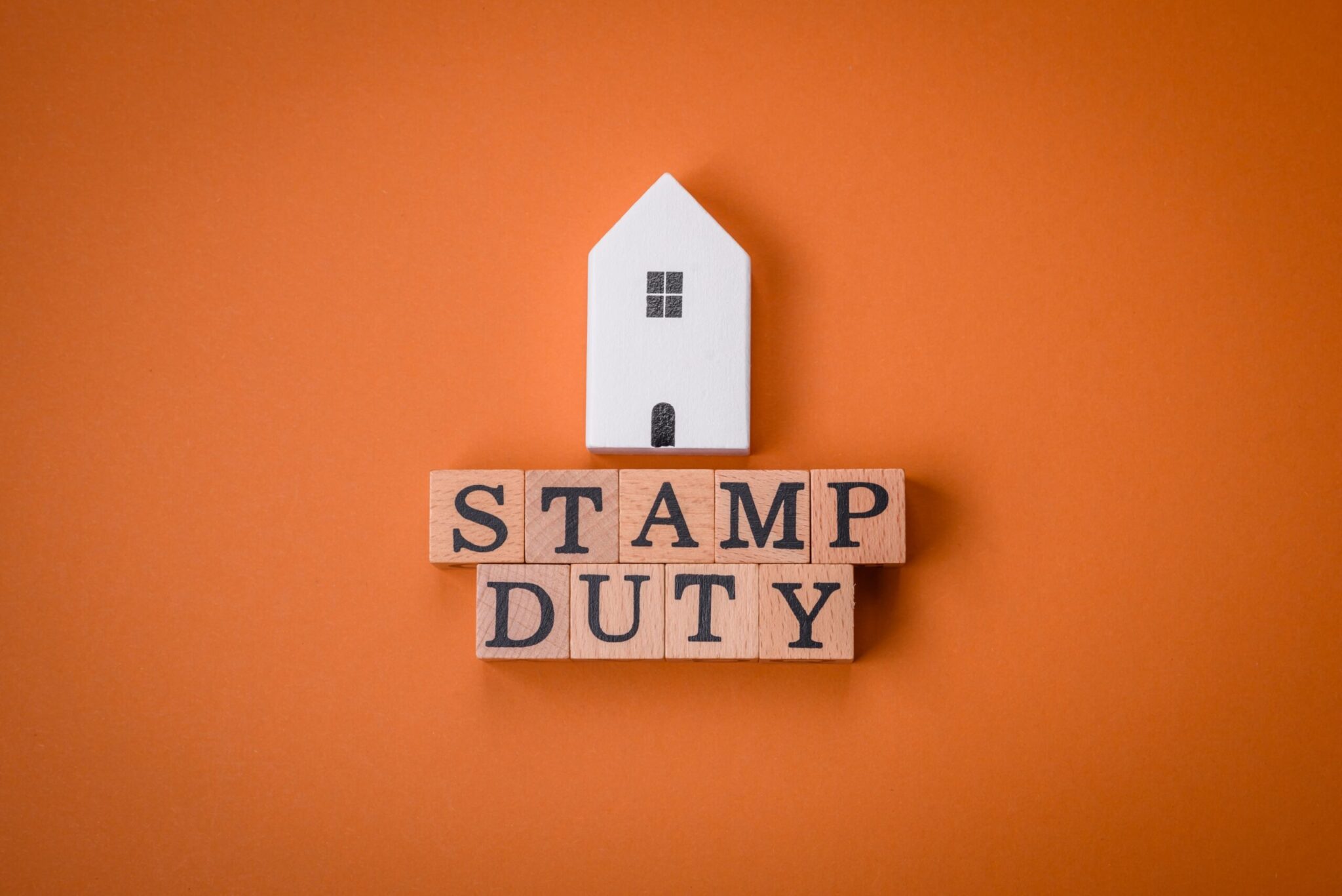 an image of a house and a sign reading 'stamp duty'