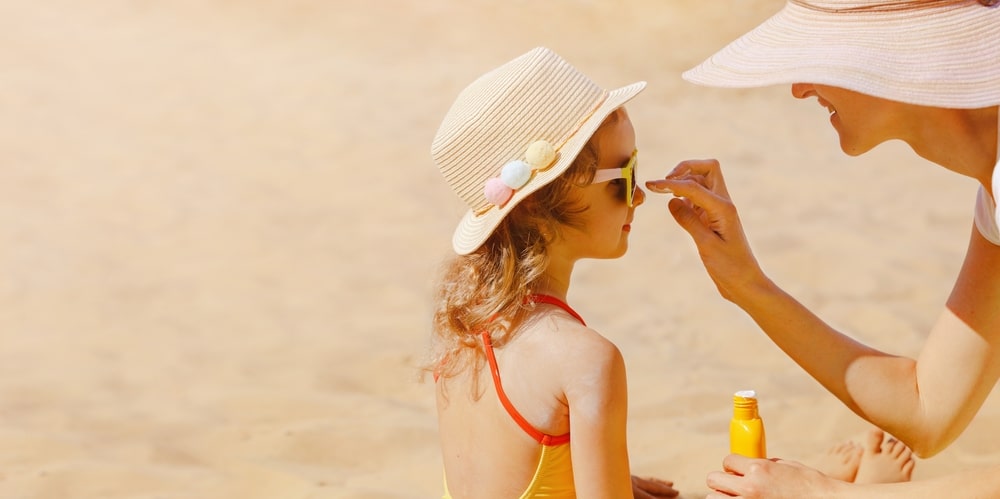 a parent putting sun cream on a child to denote a story about sun cream failing safety tests