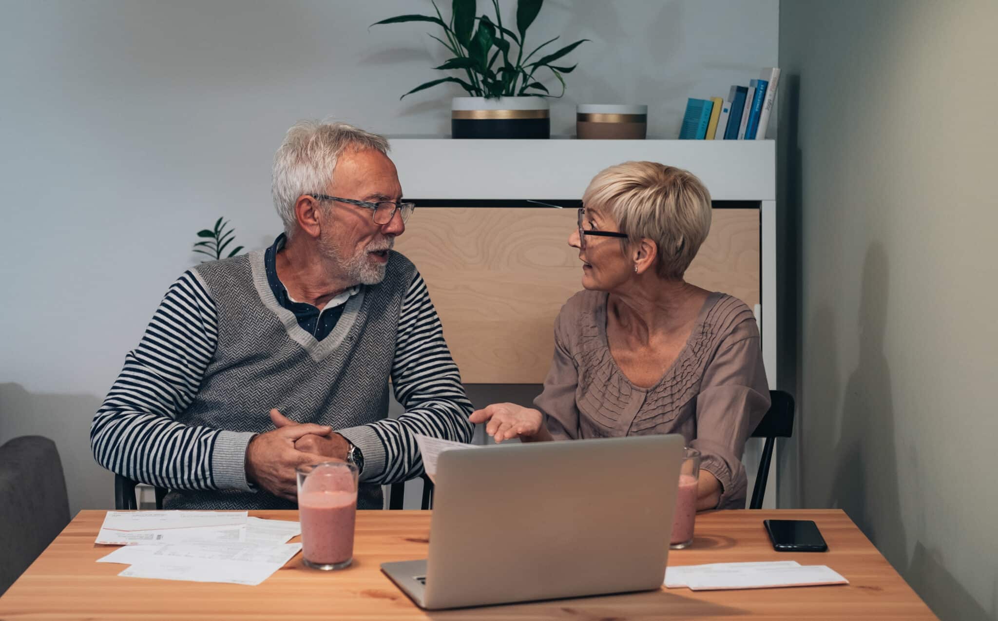 A couple aged over 50 using a laptop to denote a digital pension service launching