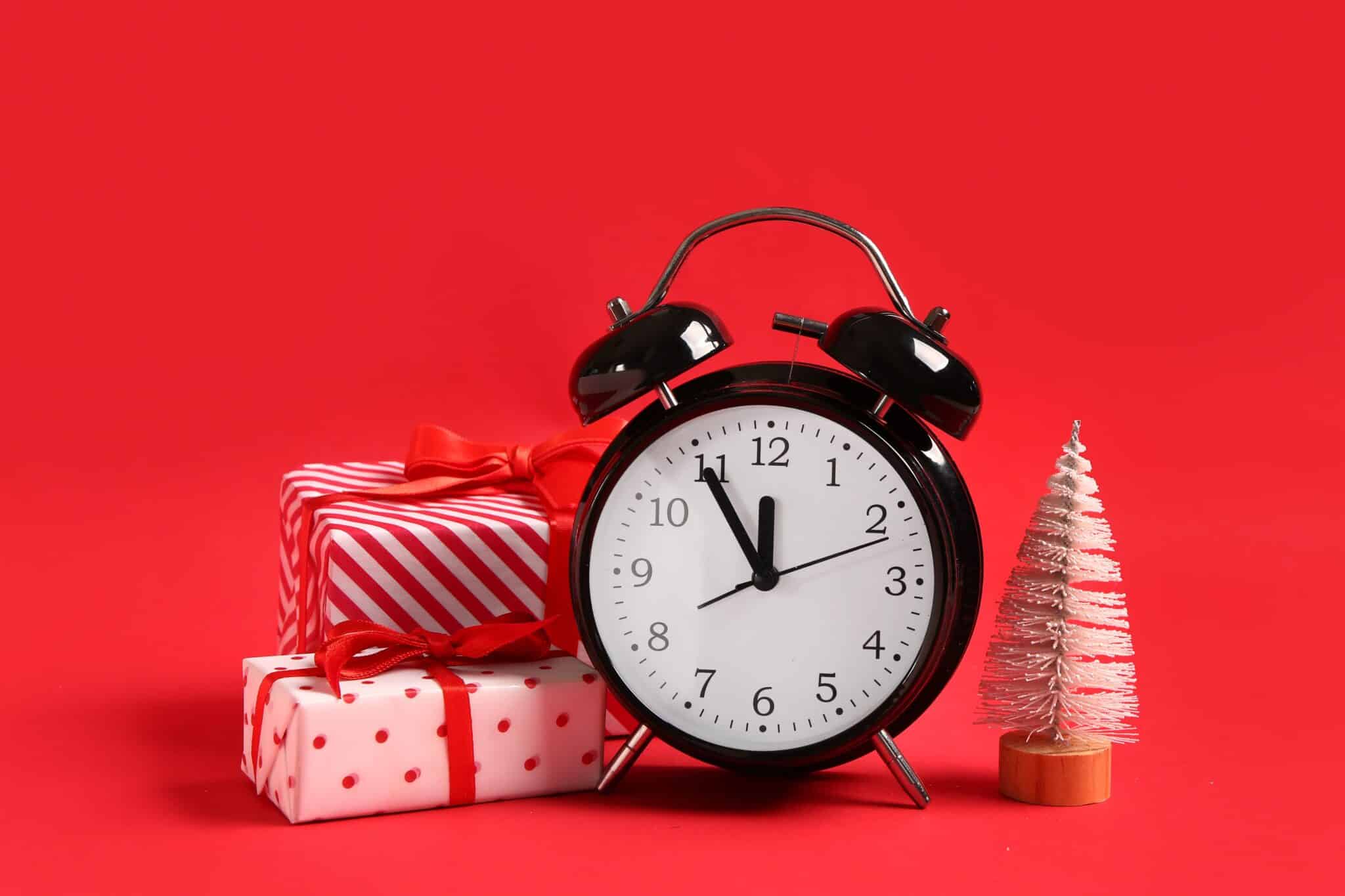 Image of an alarm clock and presents to denote its 100 days until Christmas: Spending tips for your festive finances