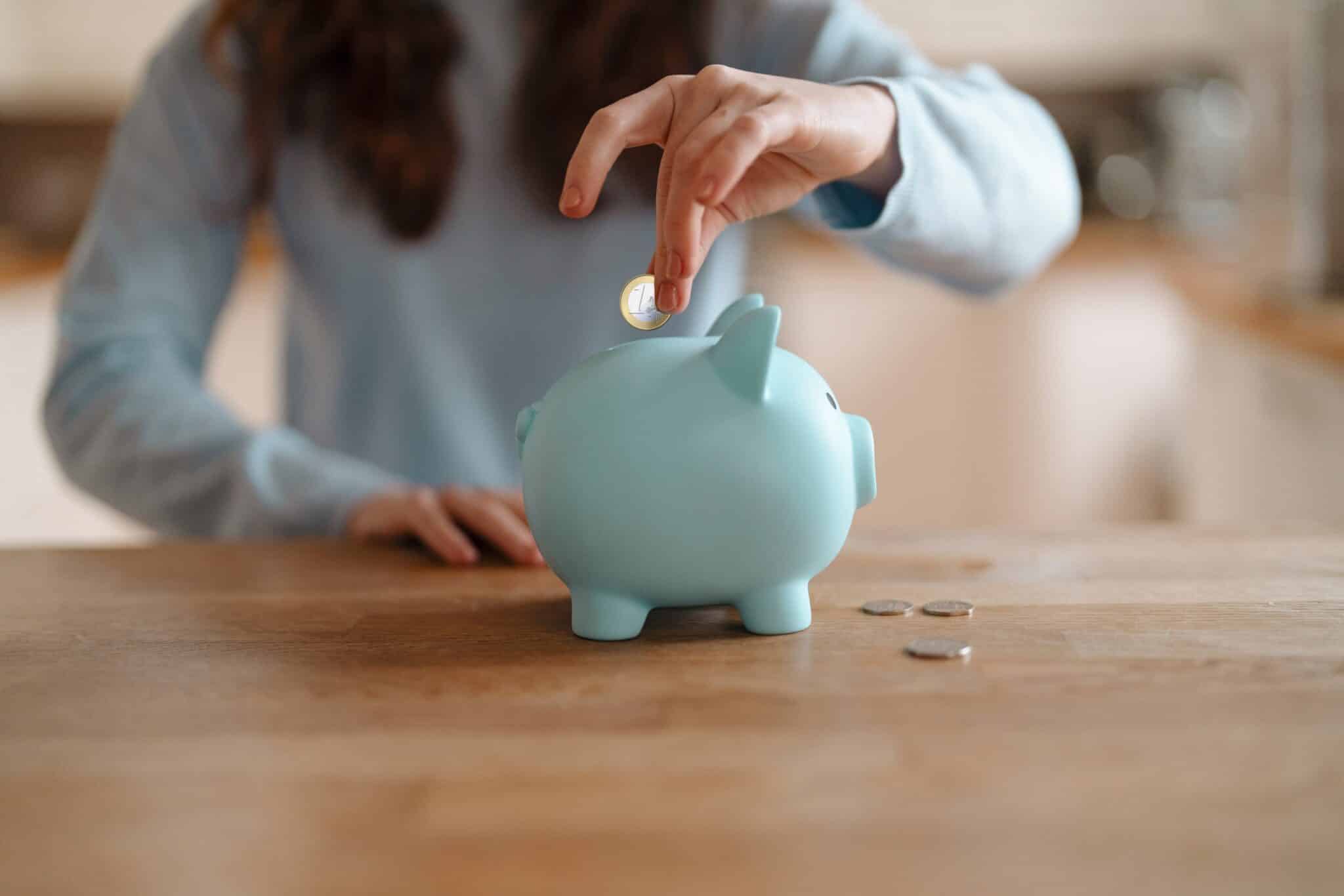 Coins being put into a piggy bank to denote a blog on regular saver accounts