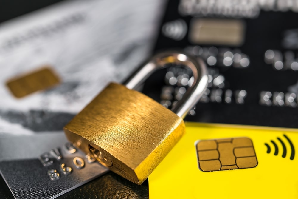 A padlock with a credit card to denote a new fraud investigation law for banks