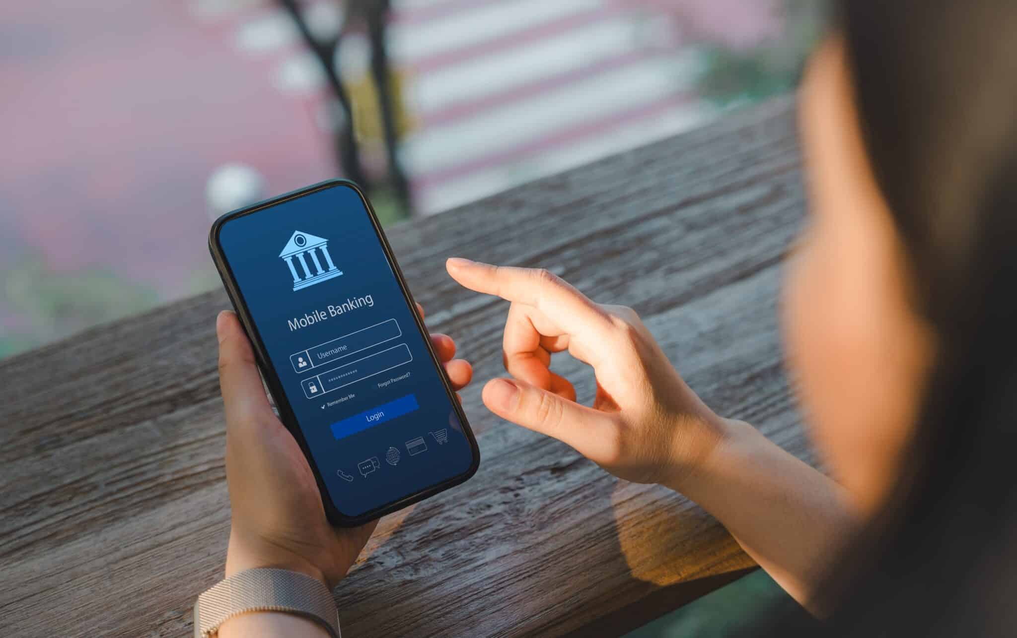 Photo of a mobile banking app held by a woman to denote how just a fifth of adults have switched current accounts in the last year