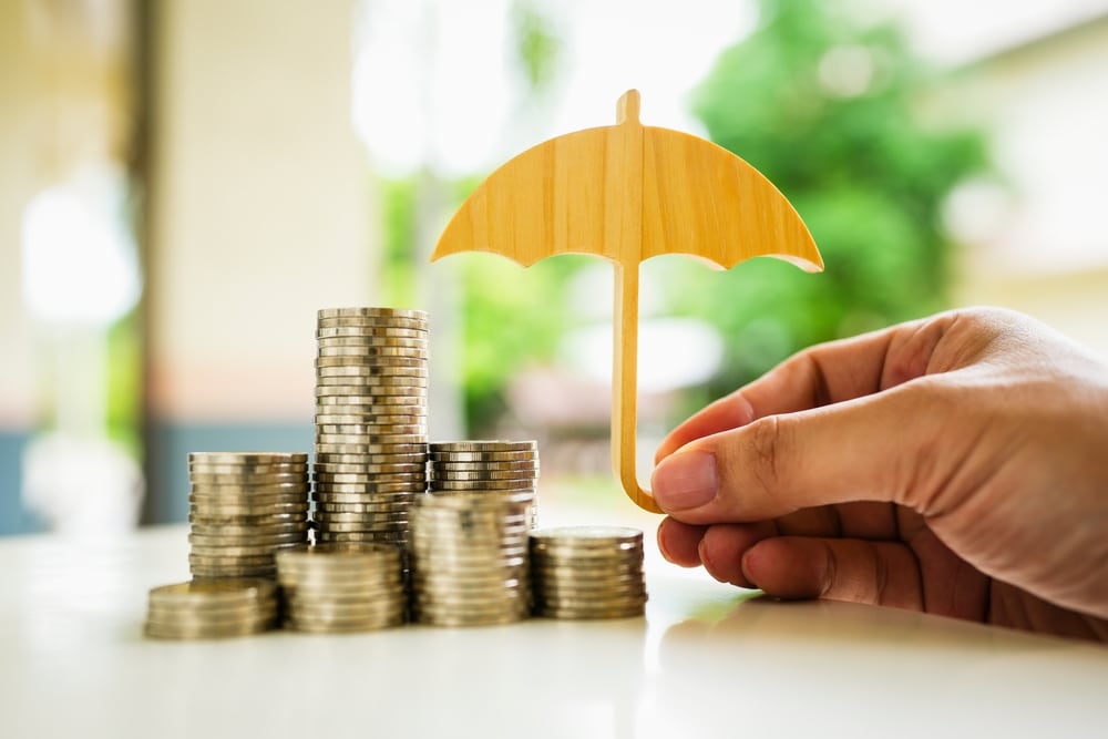 An image of an umbrella covering coins to denote a blog on affluent Brits having to protect their wealth