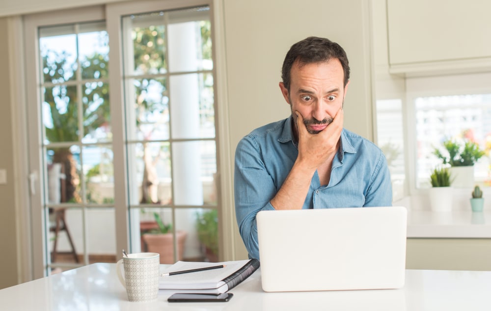 A confused man on a laptop as 55-year-olds ‘have no idea’ when they’ll retire