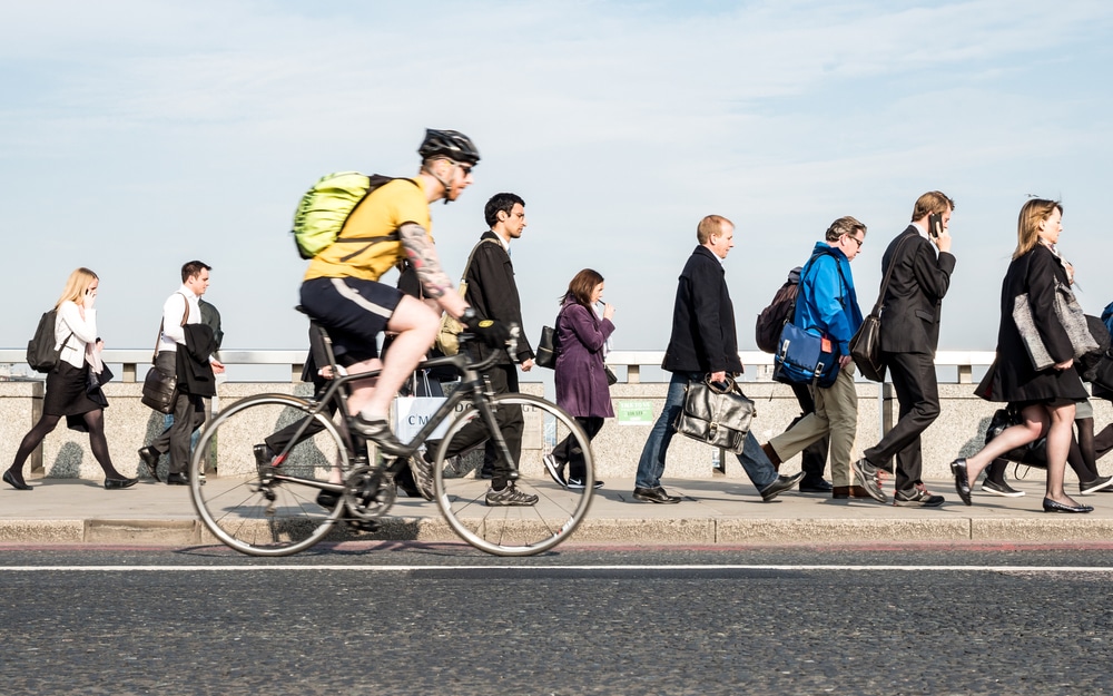 People walking to work to denote unemployment rate rises and wage growth slowing