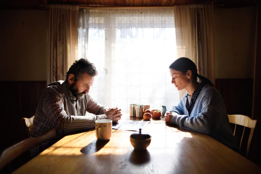 A couple sat opposite looking solemn as poorest households worse off after autumn budget