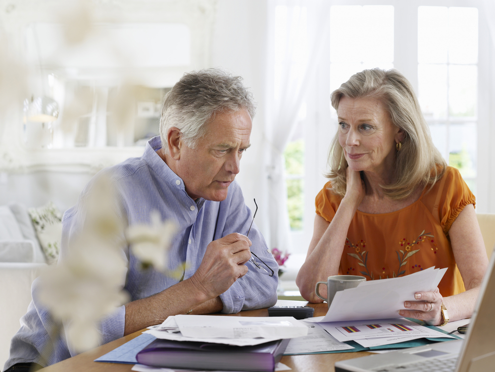 two older people looking worried to denote pensioners still paying off their mortgages