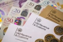 Pound notes and coins with HMRC letter on self-assessment deadline day