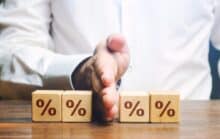 Percentage dices cut in half to denote mortgage rate cuts